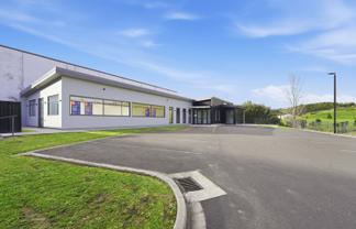 Tauriko building with 15 carparks
