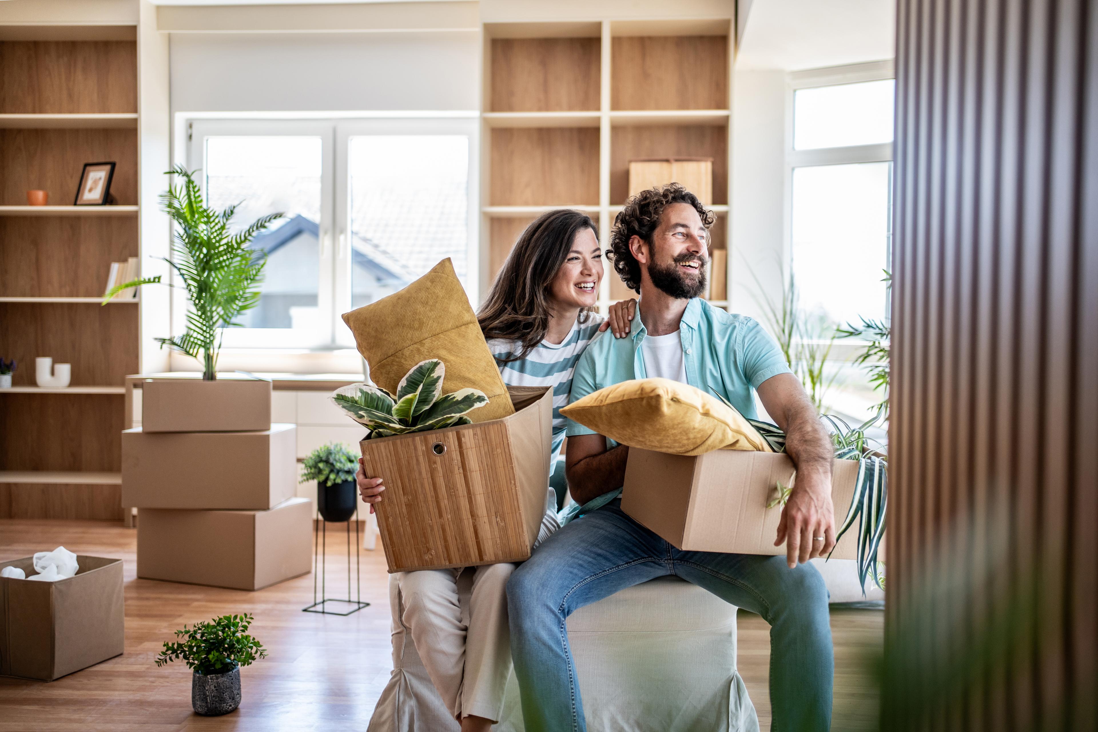 happy Kiwi couple moving into their first home in New Zealand