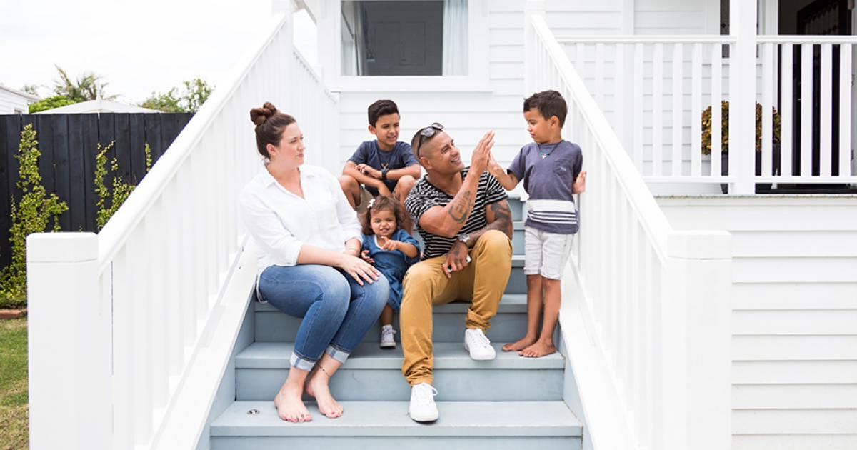 Family in a new home discussing common property insurance myths